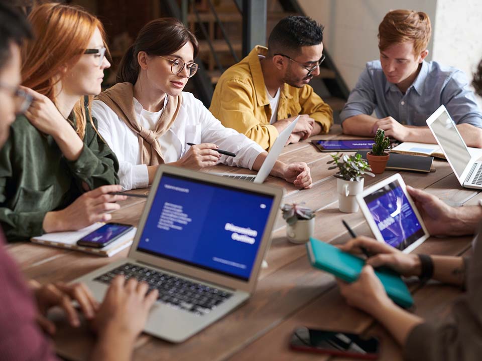 A group of young professionals have a business meeting around a table