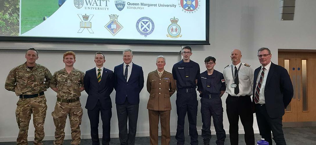 Students and Armed Forces at the event Row of students and armed forces