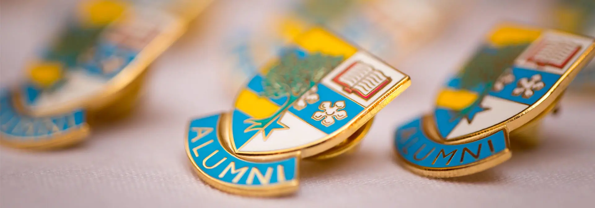 Heriot-Watt Alumni badges on a white cloth