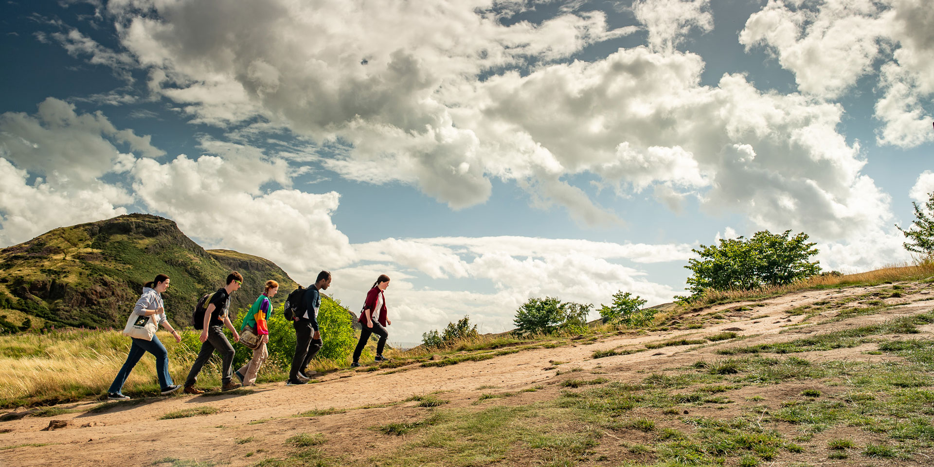 A group of students climbing Arthur's Seat in Edinburgh.