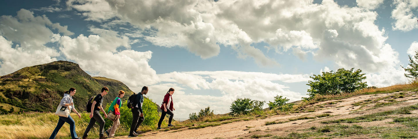 A group of students climbing Arthur's Seat in Edinburgh.