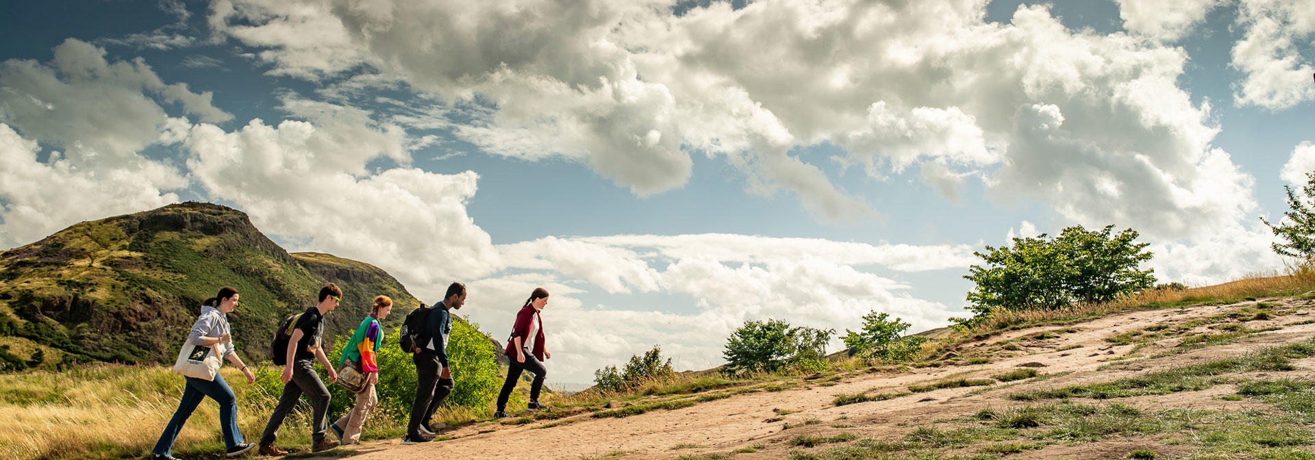 A group of students climbing Arthur's Seat in Edinburgh.