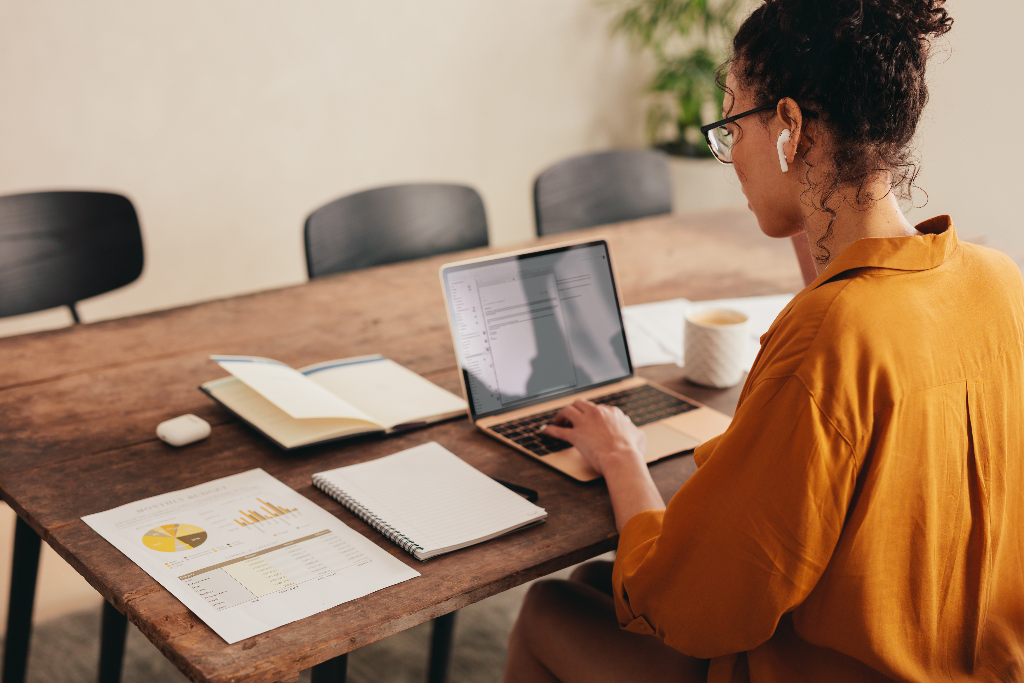 Women works on laptop at home desk