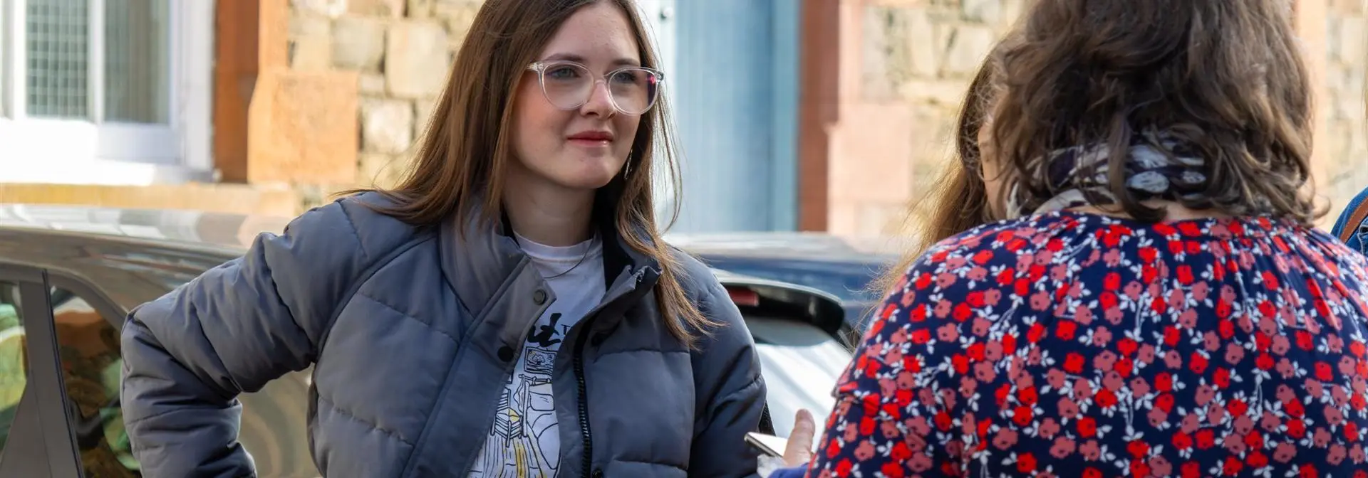Prospective student at an open day speaking to staff.