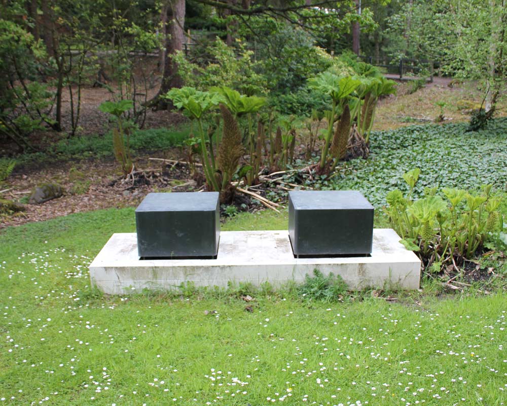 Two bronze boxes on a stone plinth
