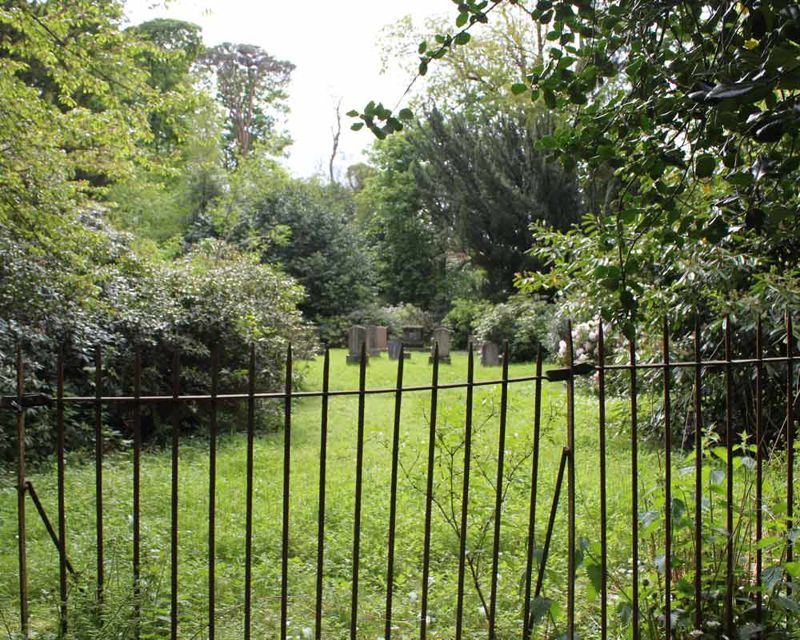 The Gibson Craig Burial Ground Headstones beyond iron railings