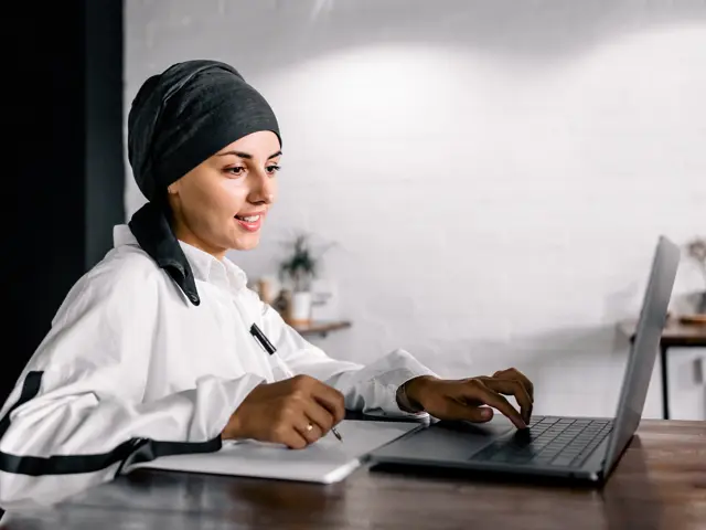 A woman working on a laptop