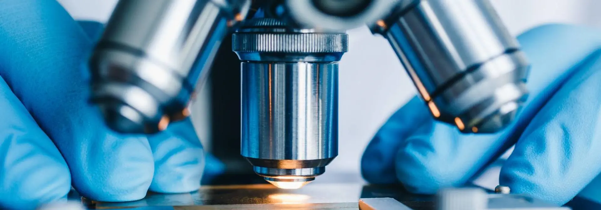 A microscope with a light looking at a slide.