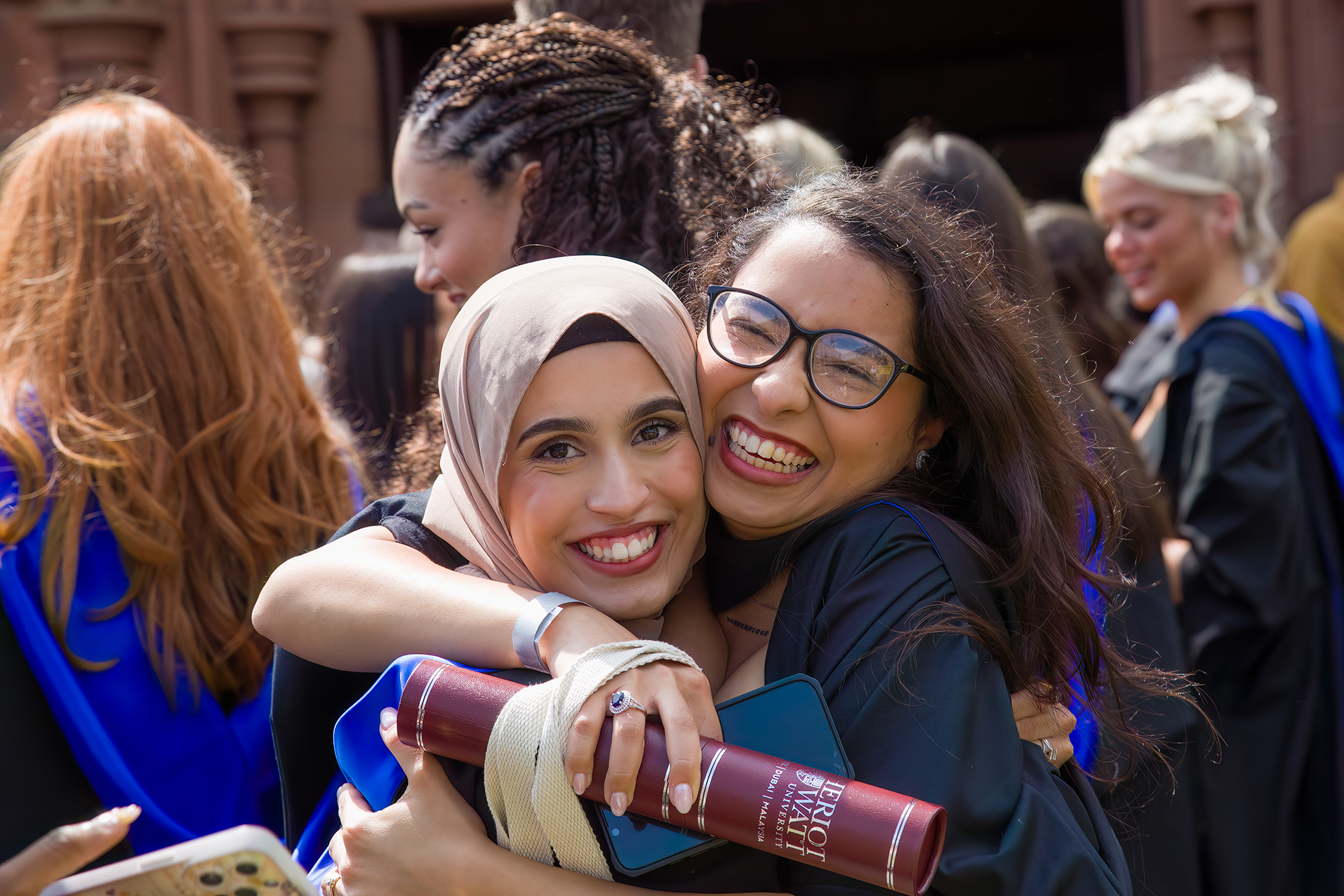 Graduates hugging