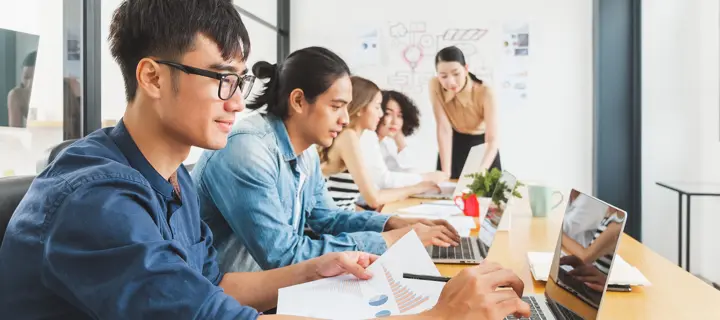 Several students working on laptops