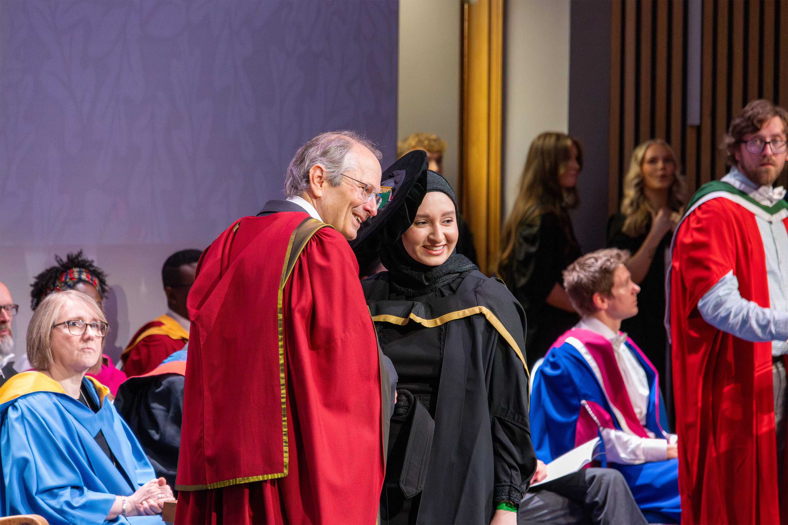 Several students in graduation robes
