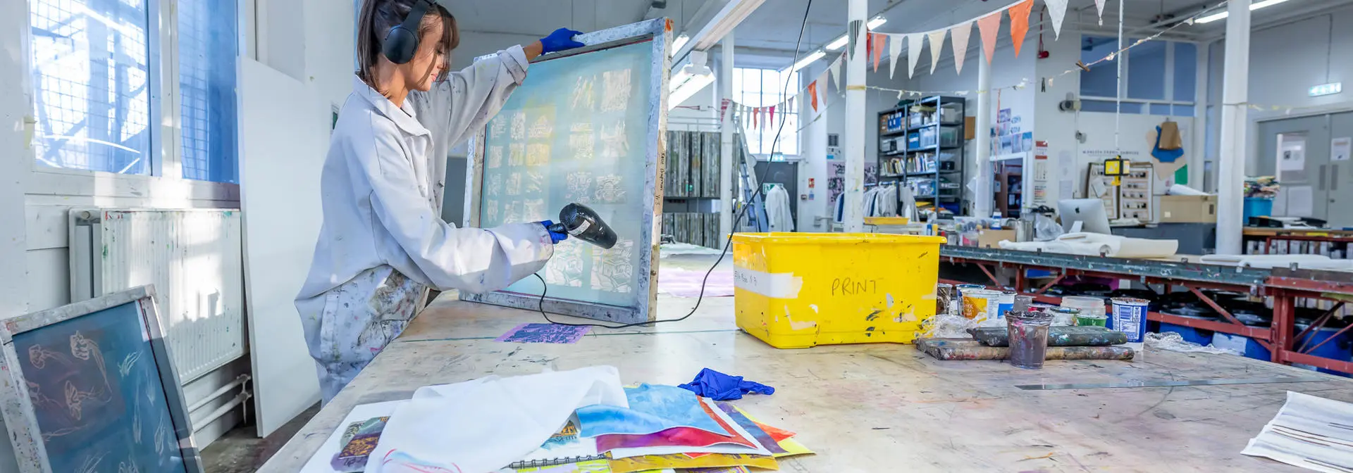 Student using screen printing equipment