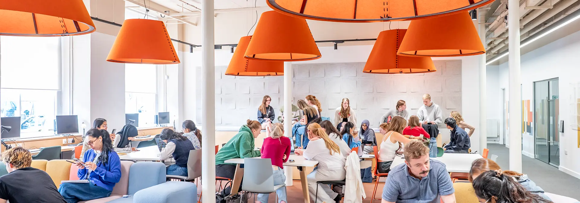 Student break-out area, busy with students working in groups