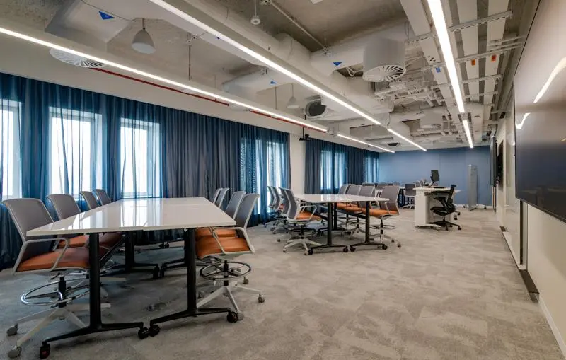 classroom with orange seats and grouped tables.
