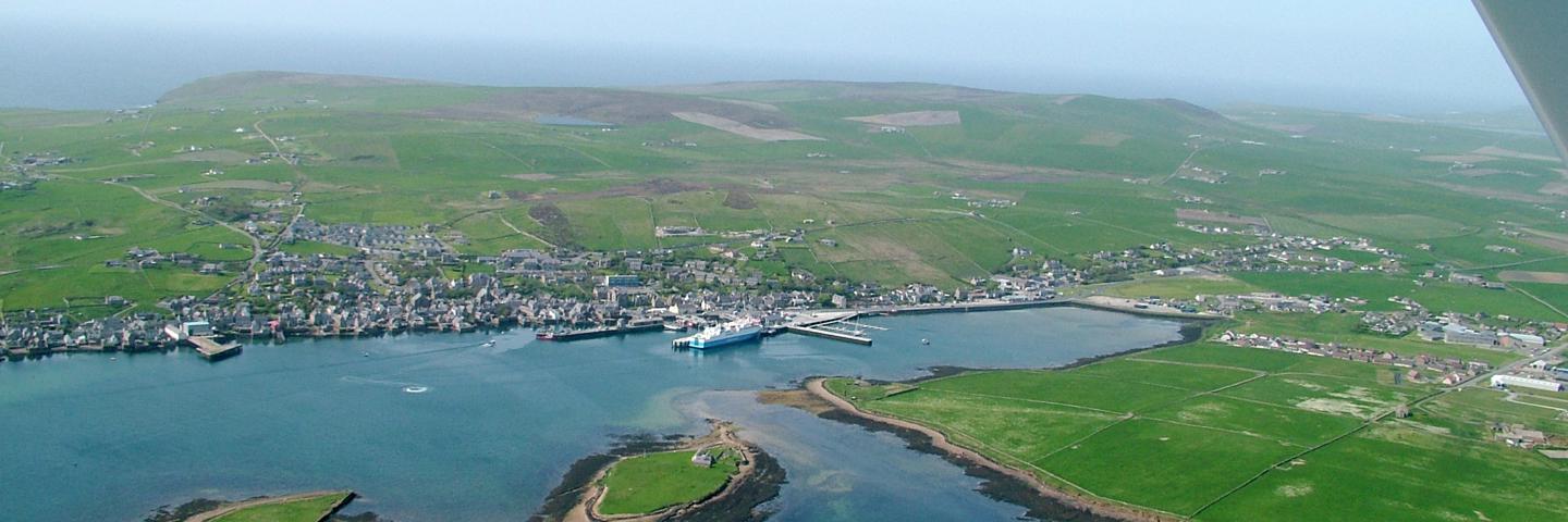 A faraway view of Orkney town and coastline