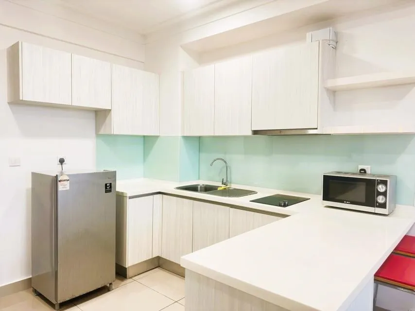 Kitchen and dining area Kitchen and dining area, showing cupboards, worktops, microwave, sink, fridge and stools