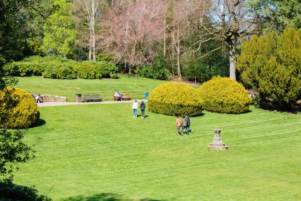 Students in the Sunken Garden at the Edinburgh Campus Picture of students walking across a lawn on a sunny day.
