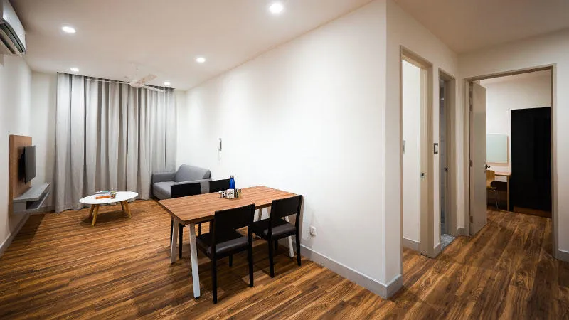 Living hall LIving hall showing wooden floor, table and chairs, couch and television