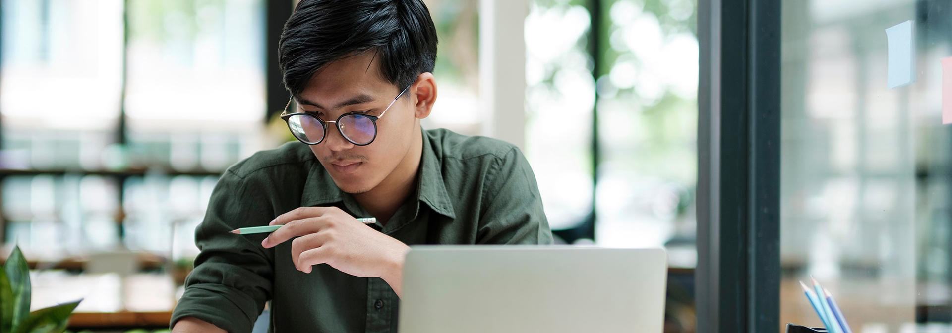Student works on a laptop reviewing documents.