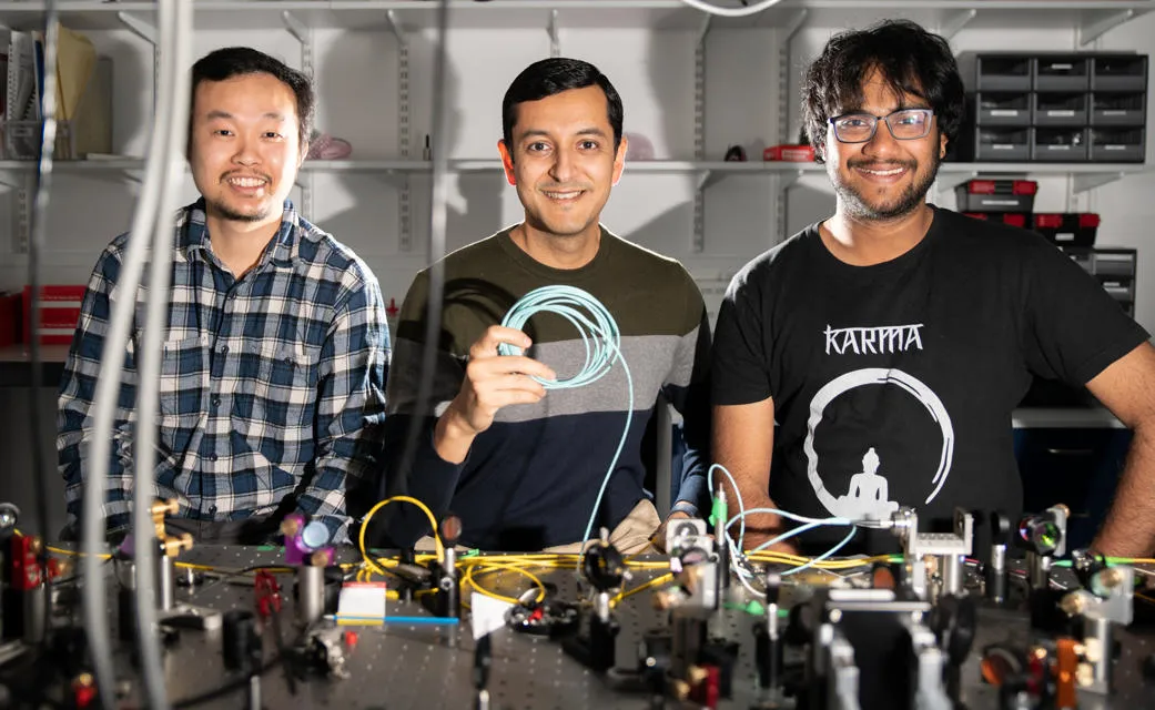 Professor Malik with members of Heriot-Watt’s Beyond Binary Quantum Information Lab (BBQLab), Dr Saroch Leedumrongwatthanakun (left) and PhD student Suraj Goel (right).