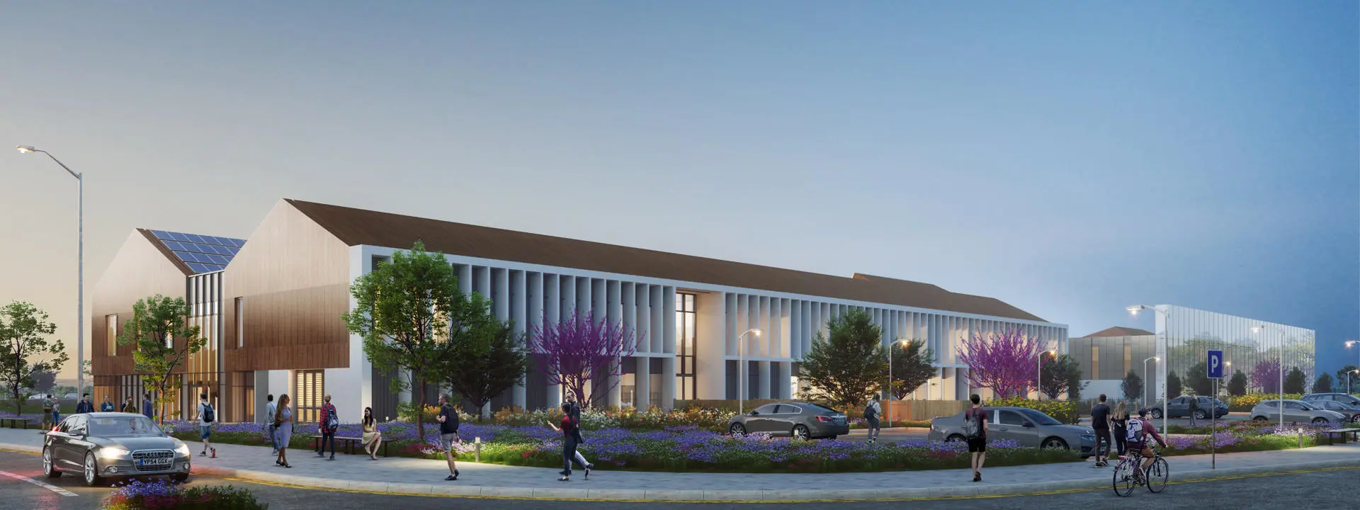 A vibrant university campus with people walking, cycling and driving around