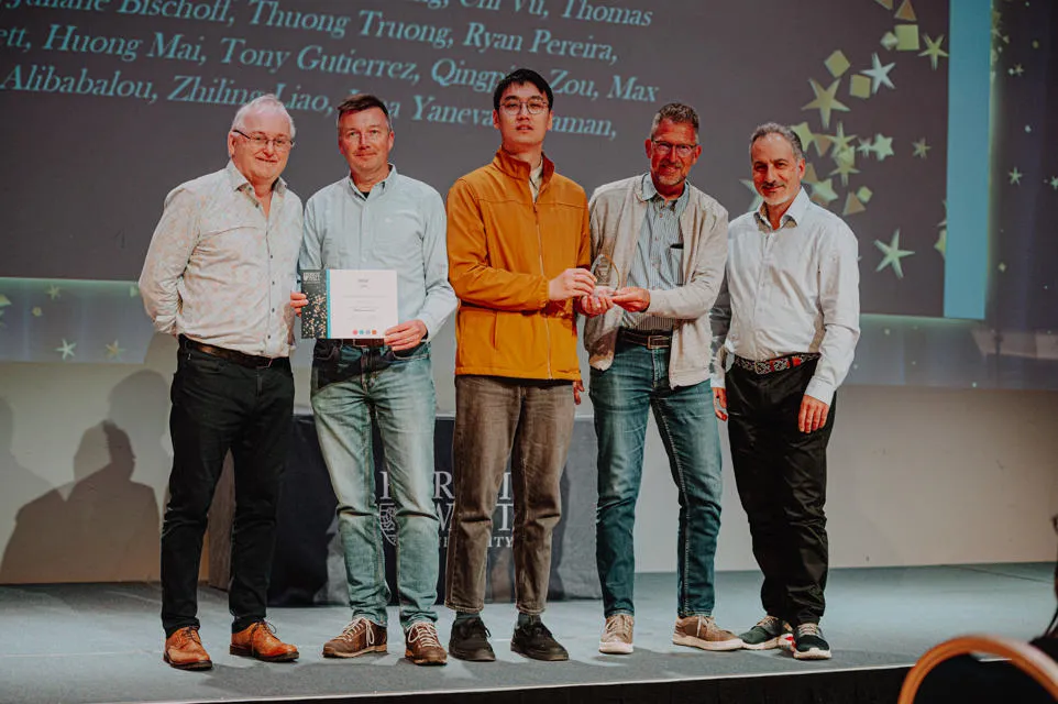 4 people receiving an award from the Vice Principal