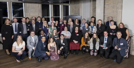 A group of people accepting awards