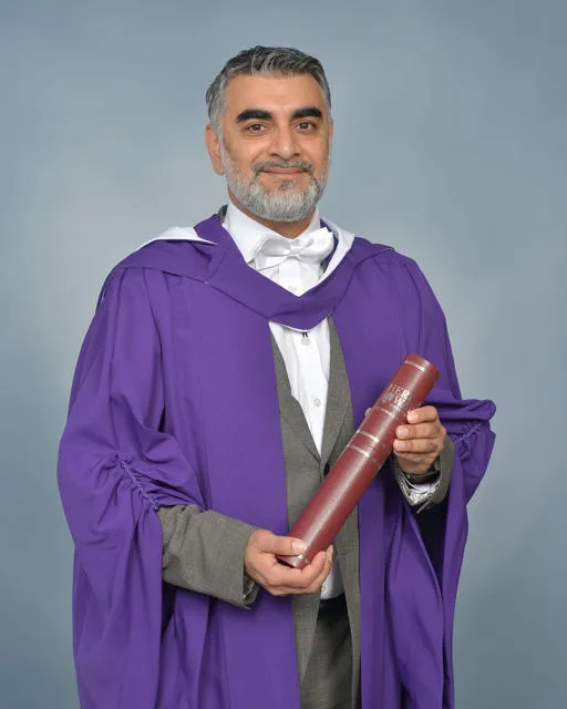 Images of Dr Omar Shaikh in his graduation gown holding his academic scroll.