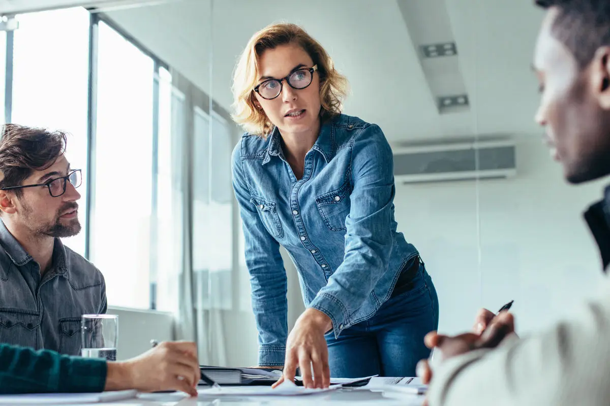 Woman at desk explaining business information.