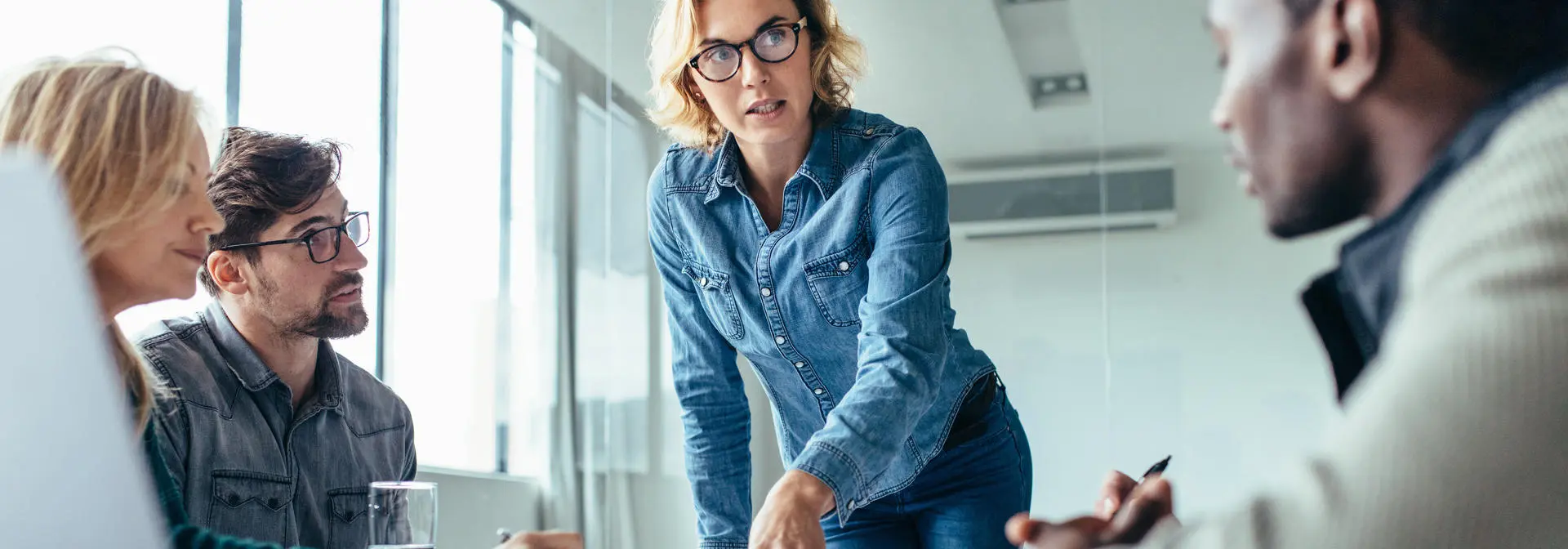 Woman at desk explaining business information.