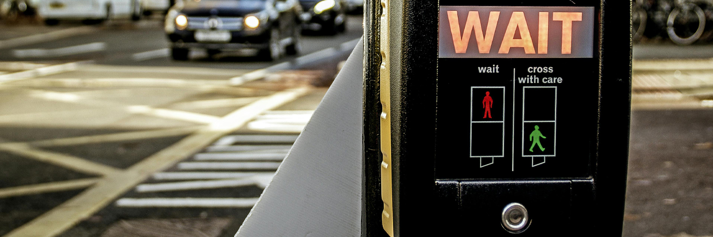 Pedestrian crossing signal displaying "WAIT" 