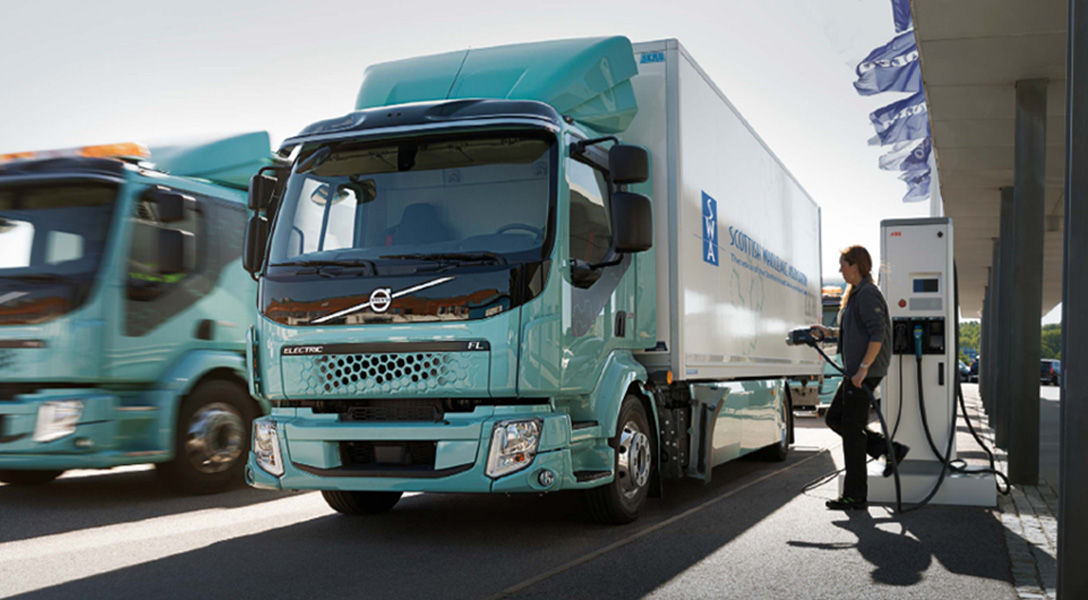 Volvo electric trucks awaiting charge showcasing innovative technology and environmentally friendly design.