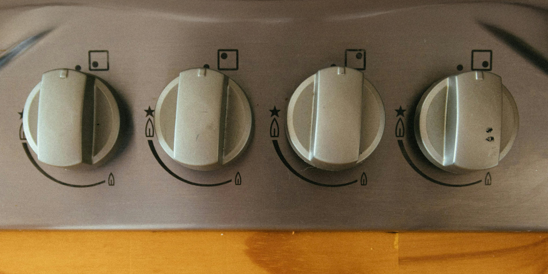 Close up of cooker control dials, all turned off.