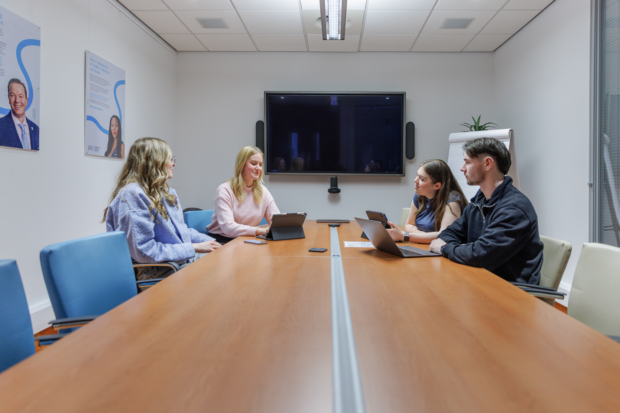 Students working together in a meeting room
