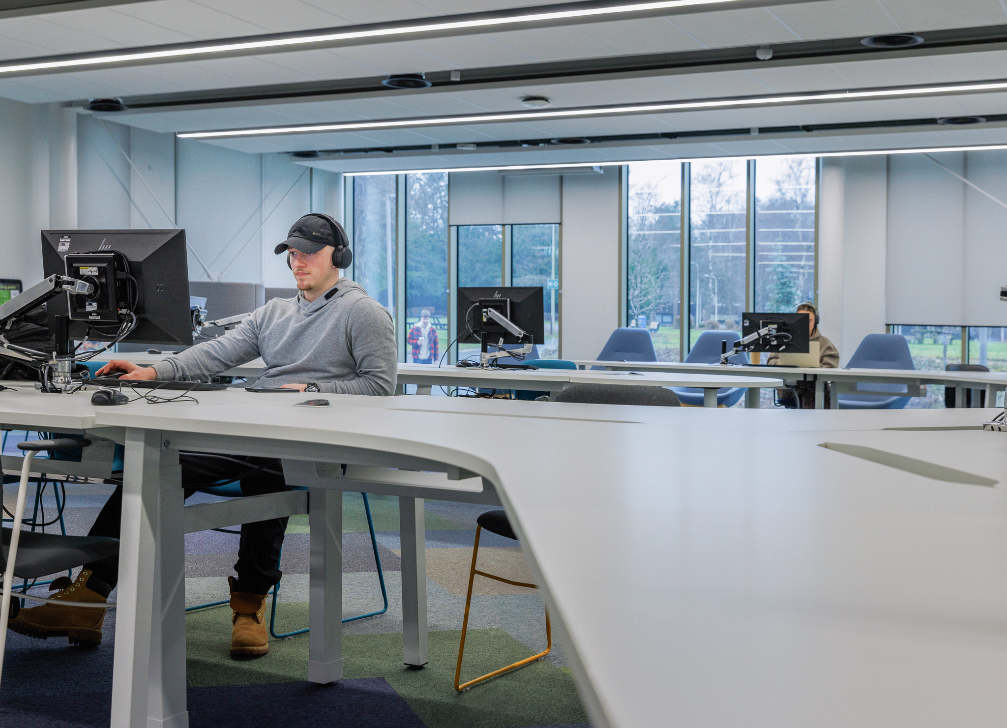 Student working on a computer in a common area
 