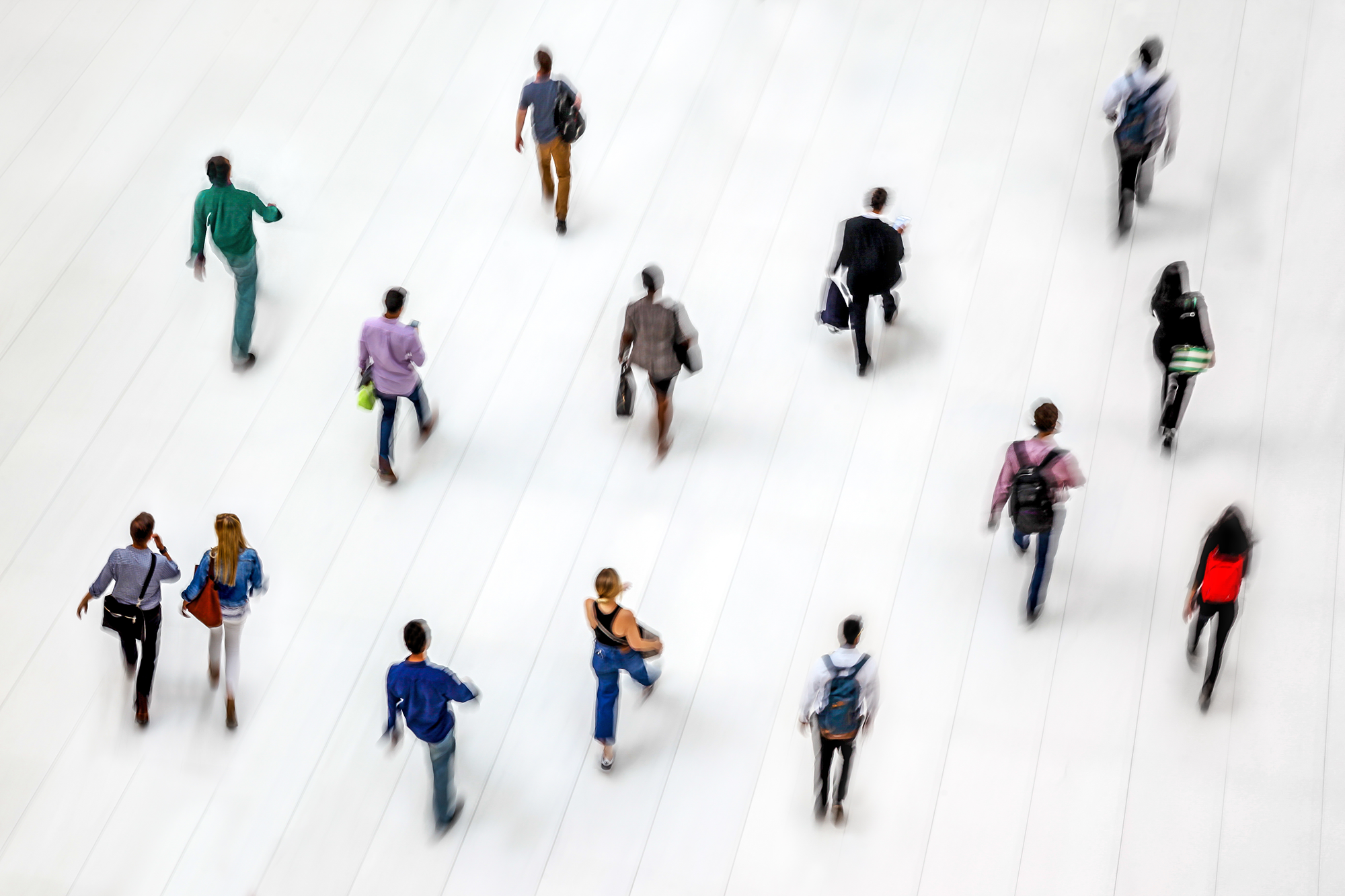 People walking in a white-tiled hall