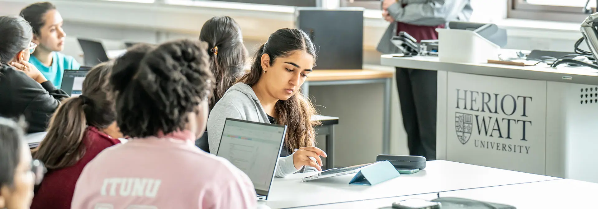 Professor talks to students in a classroom