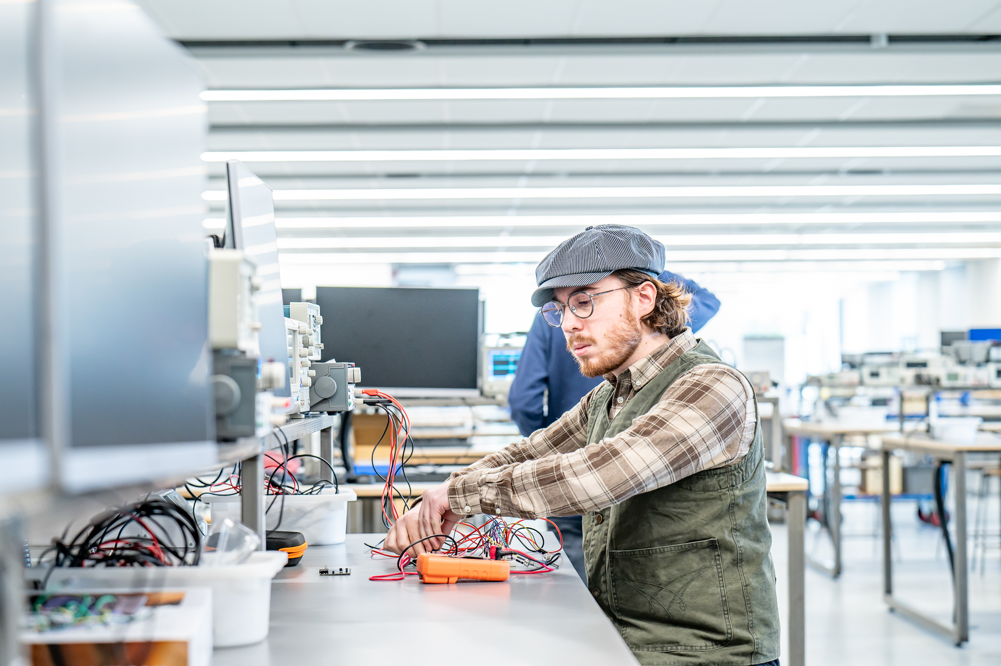 Student working on electrical equipment in a lab
