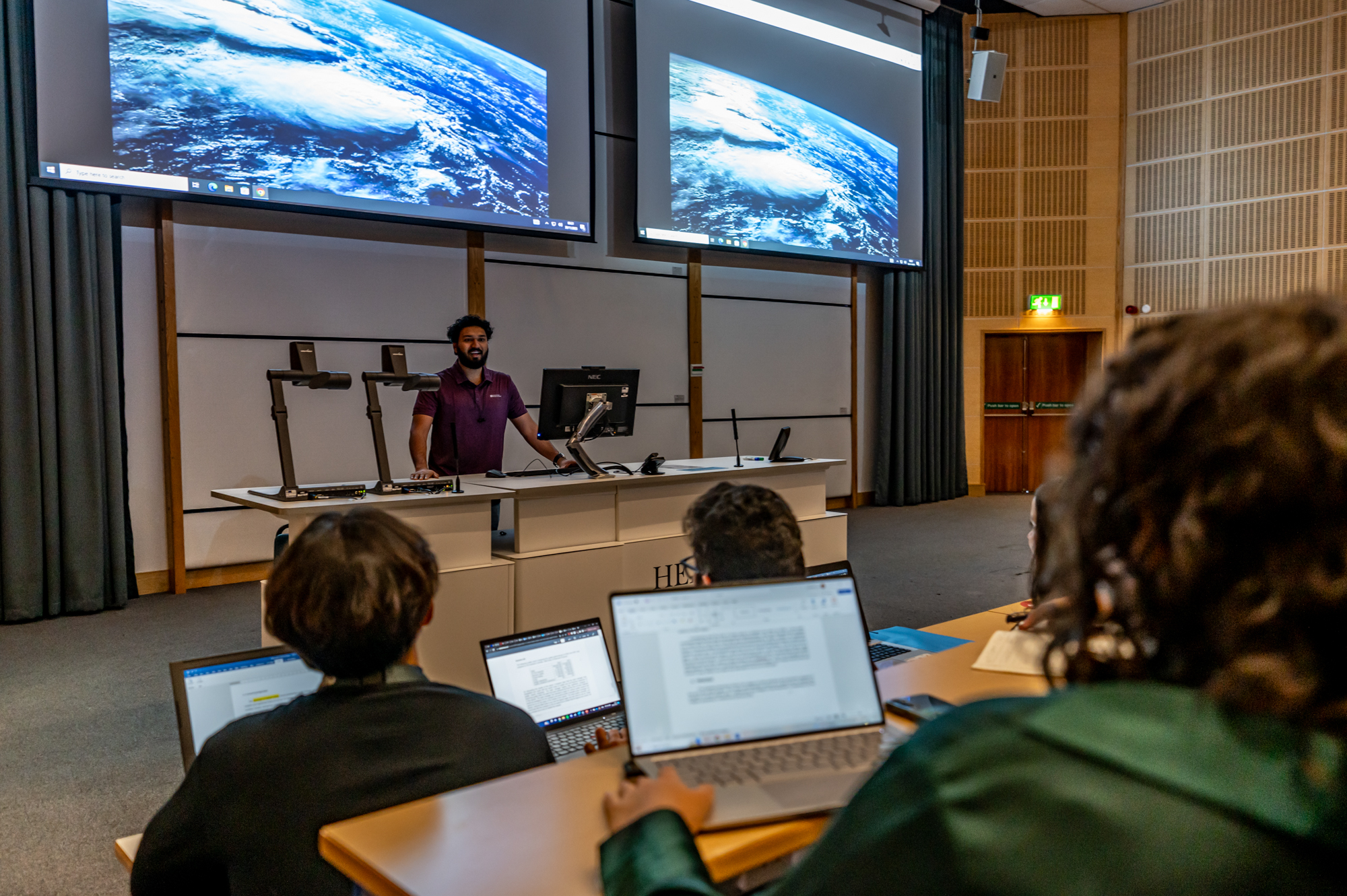 Student giving a presentation in a lecture room