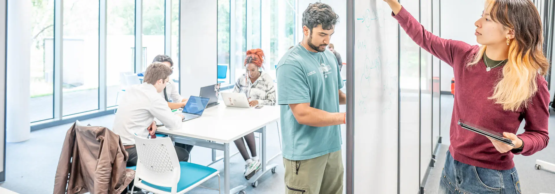 Students working on a whiteboard in a maths gym