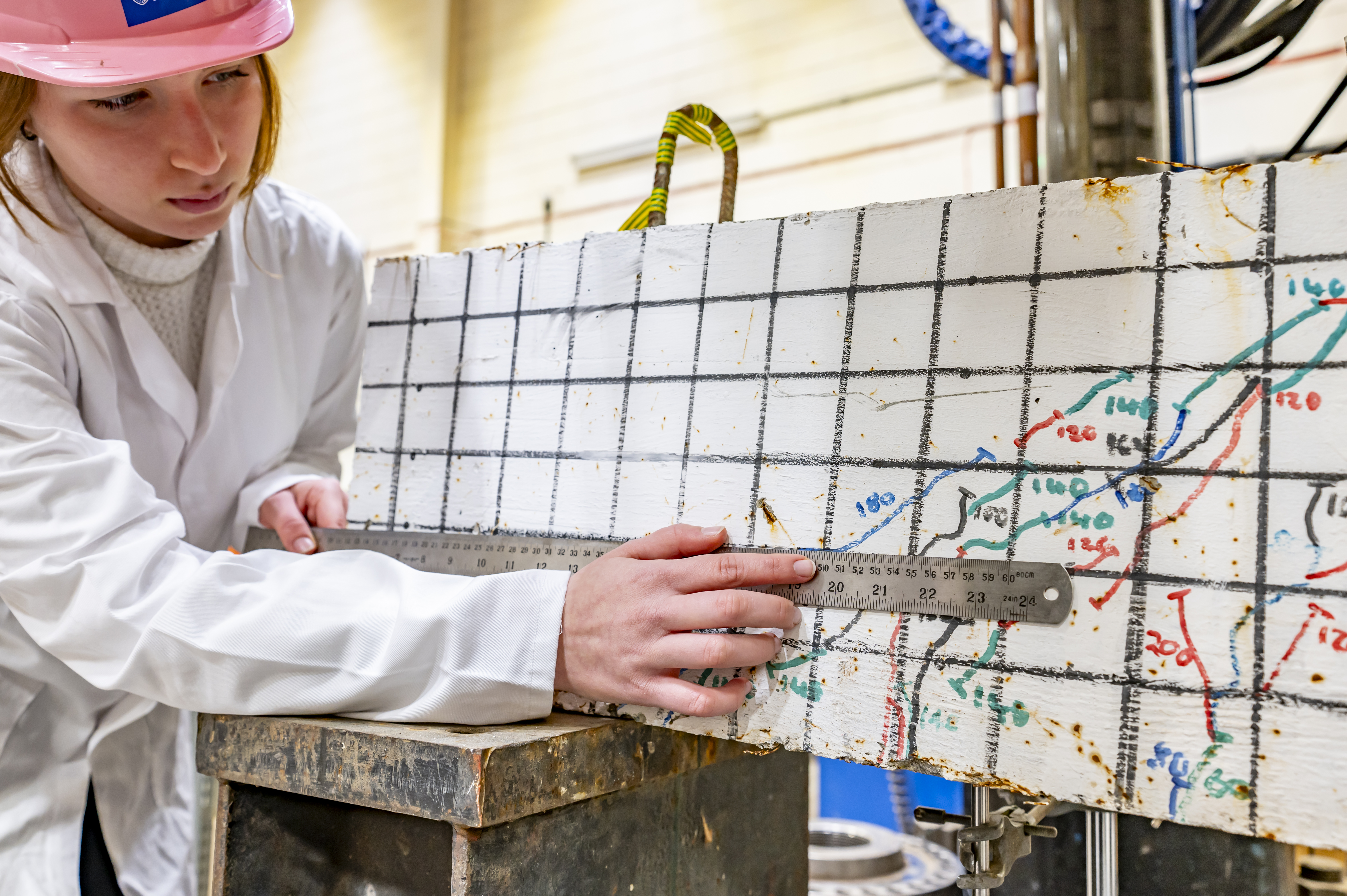 Student measuring structural movement under pressure