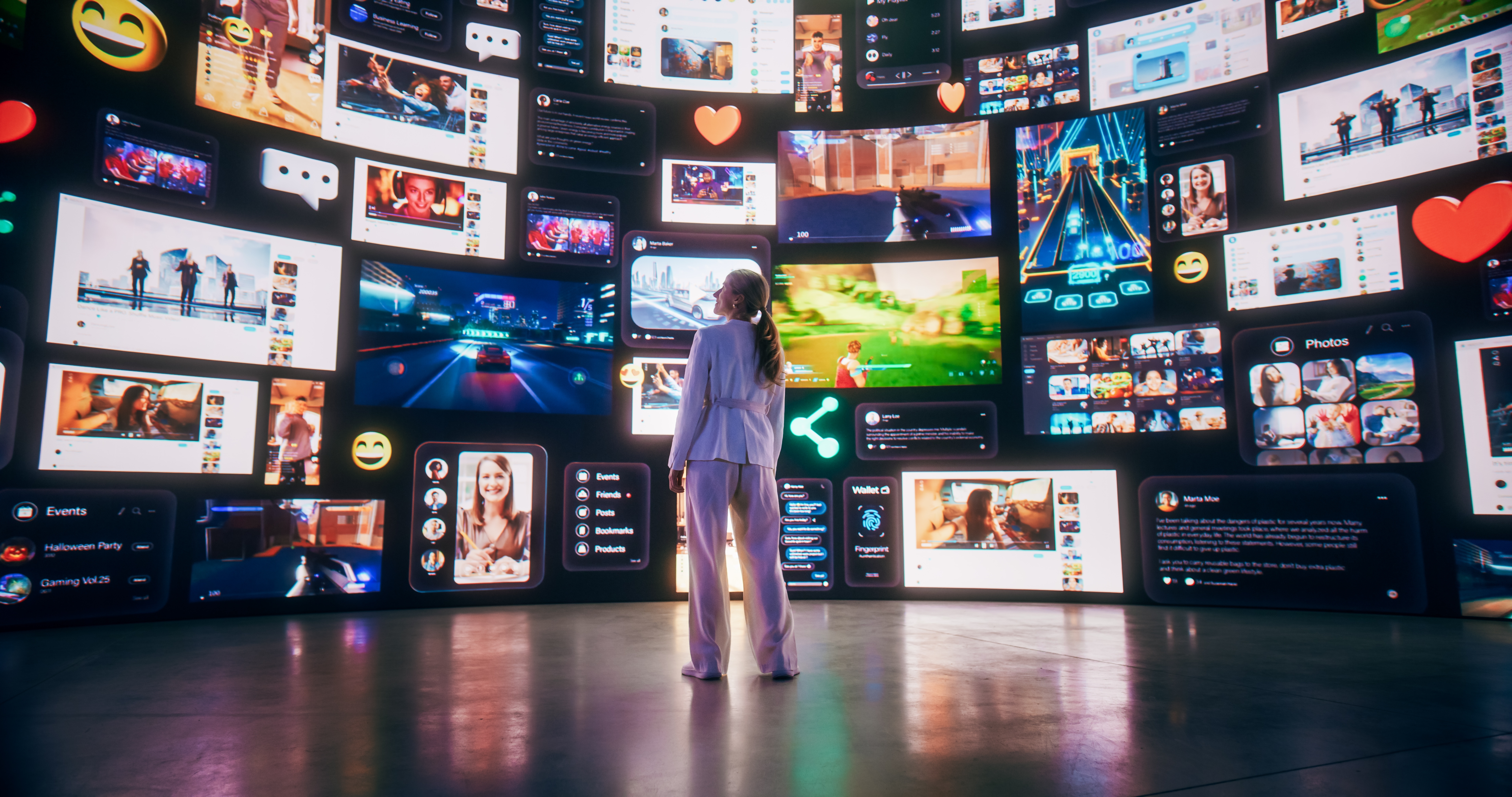 A person standing before a large, curved collage of screens with digital content representing a digital experience.