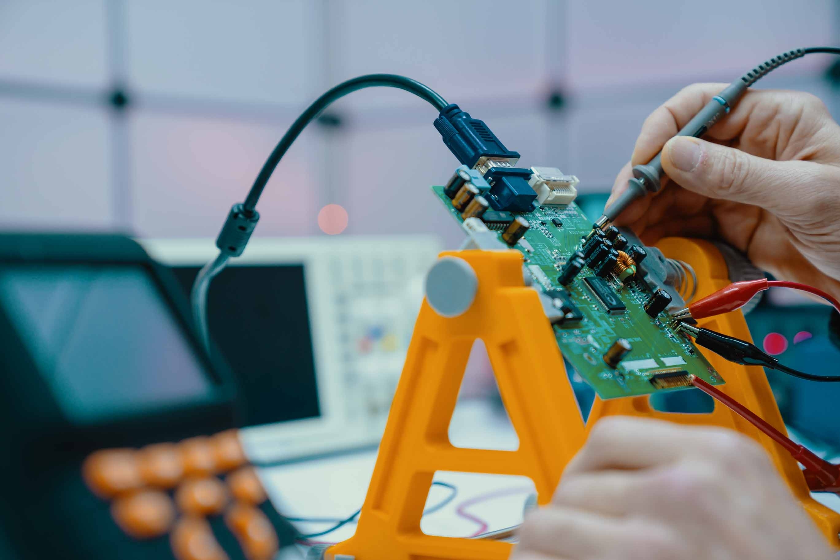 engineer testing continuity of a circuit board