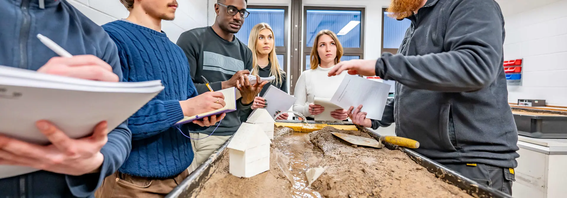 Students listen to a Geography tutor