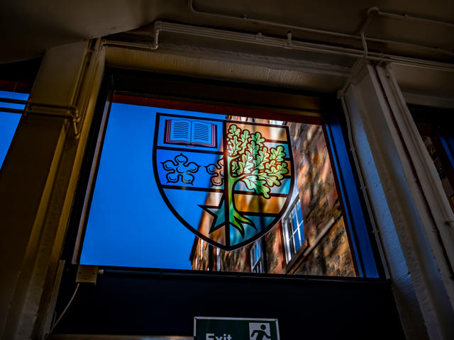 The Heriot-Watt University badge in a stained glass window.
