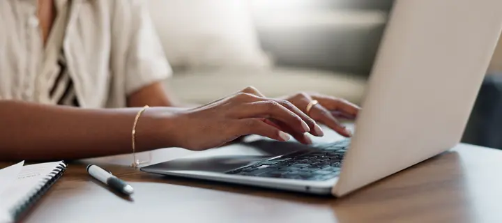 hands typing on laptop
