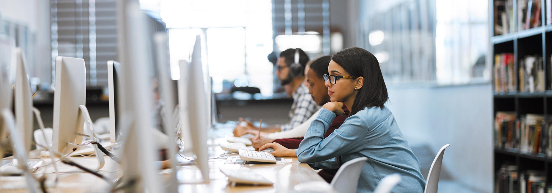 A student working in the library on a computer