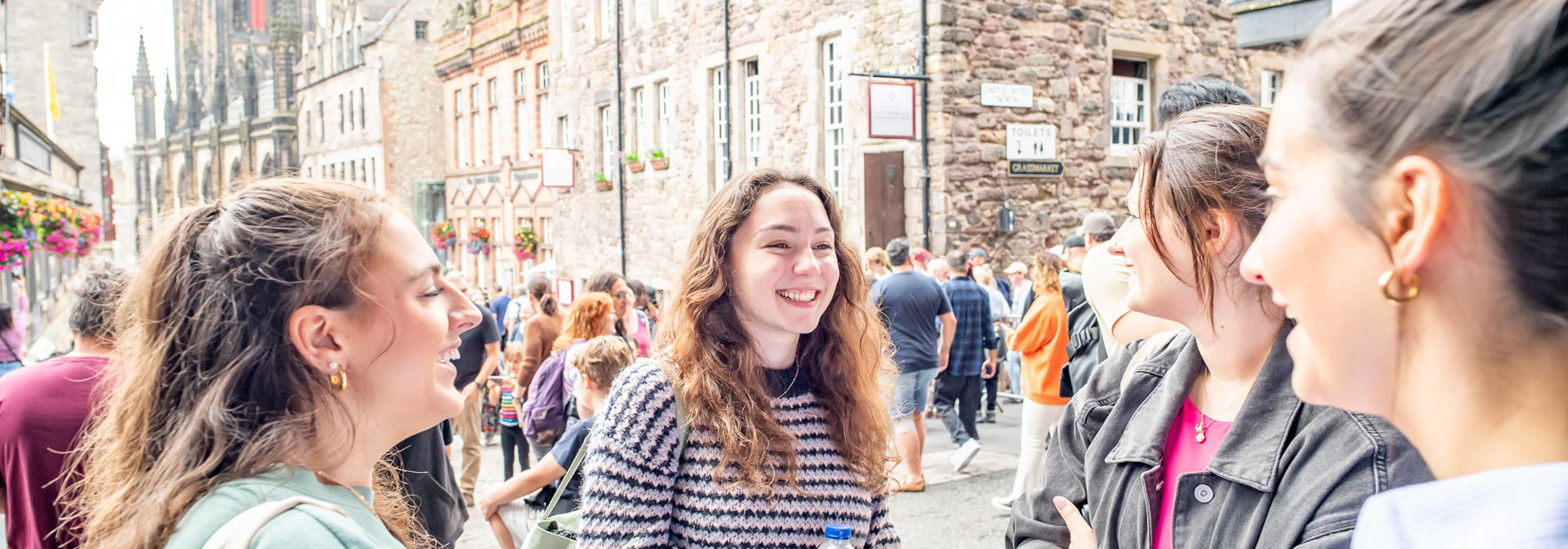A busy street with individuals talking animatedly in a group.