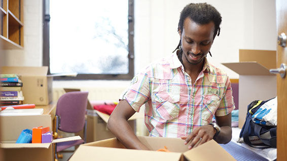 A student unpacking a box