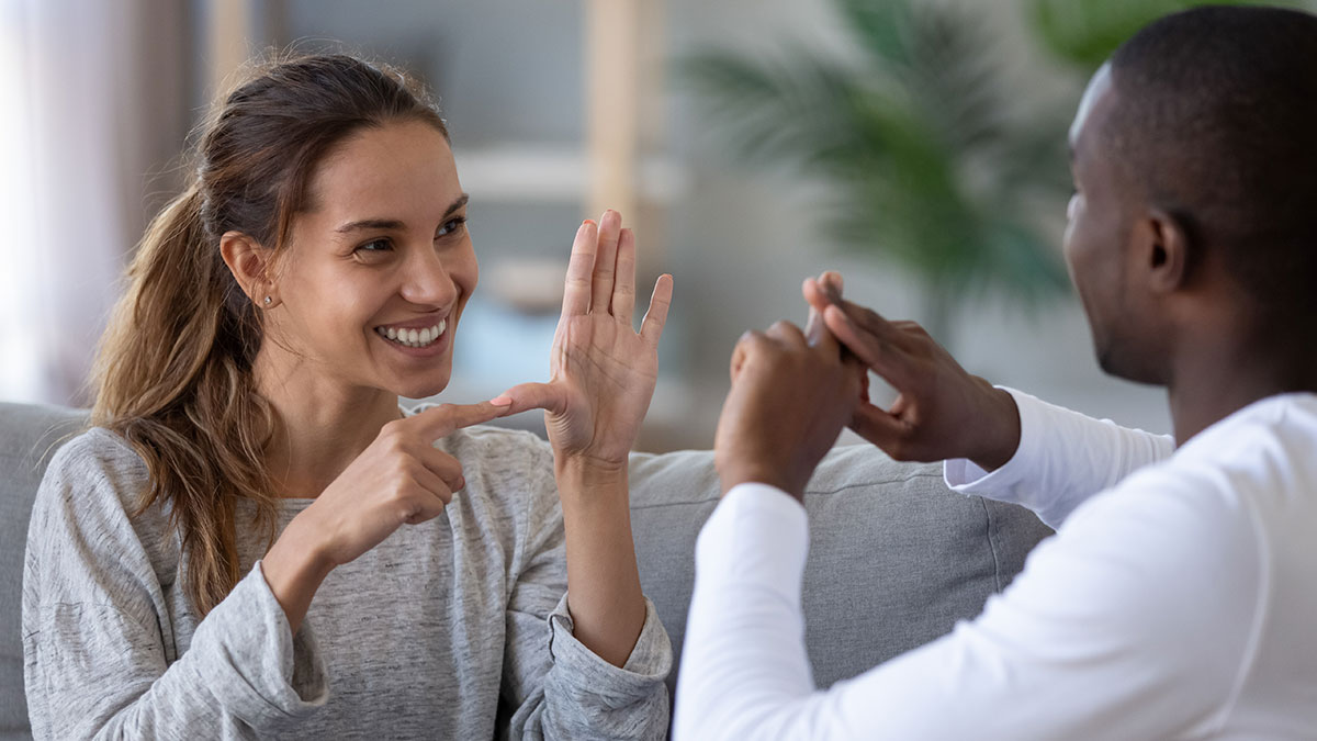 Woman and a man converse in sign language